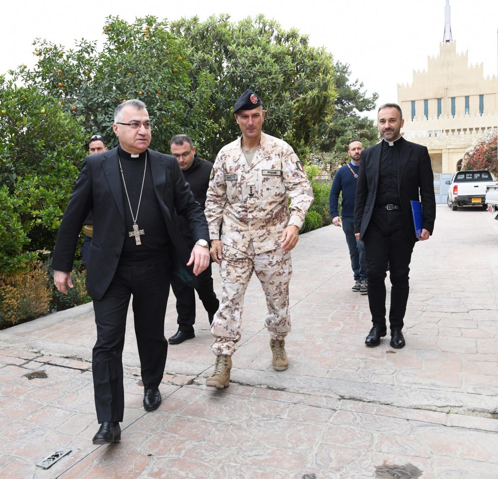 L’arcivescovo di Erbil, Mons. Warda, il comandante della missione italiana, Col. Pisani, e Don Bruno. Sullo sfondo, la cattedrale caldea.